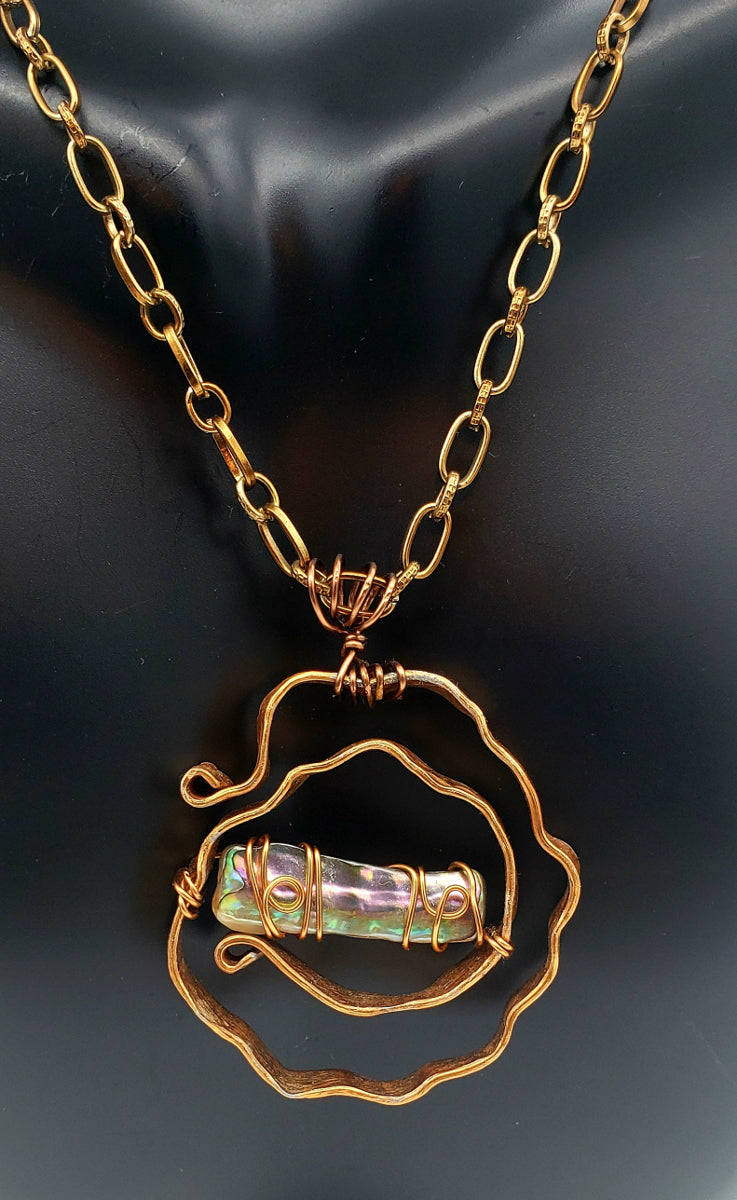 Worn view of Abalone Shell Necklace handcrafted with antiqued copper and sculptural detail. 