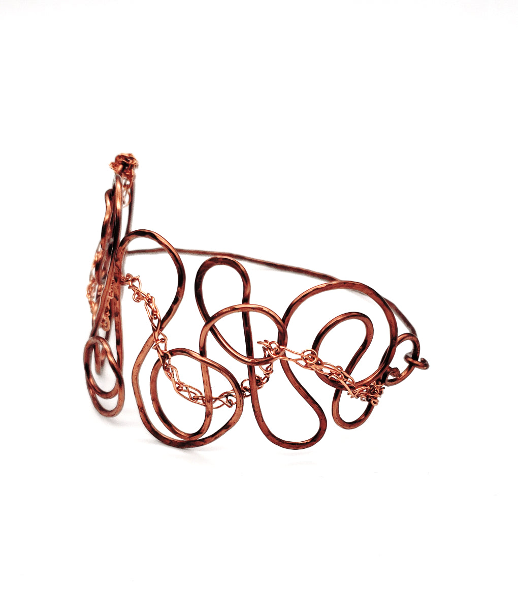 One-of-a-kind antiqued copper bangle showing sculptural wire loops and intricate crochet detailing