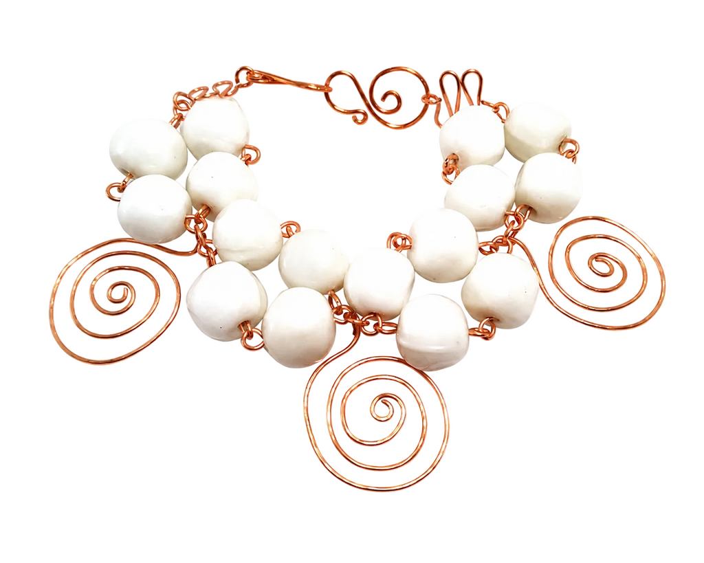 One-of-a-kind sculptural copper and ceramic bracelet with white ceramic beads and hand-shaped copper spiral accents