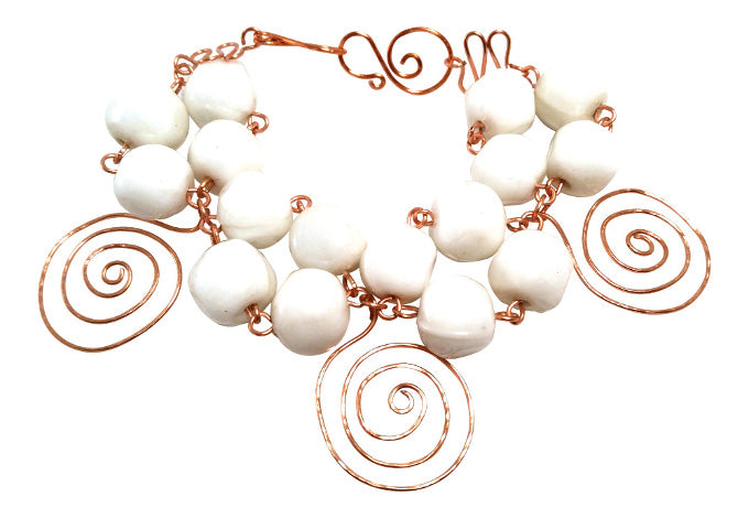 One-of-a-kind sculptural copper and ceramic bracelet with white ceramic beads and hand-shaped copper spiral accents