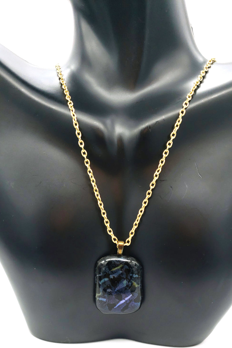 Dichroic fused glass pendant necklace displayed on a black jewelry bust
