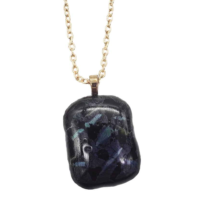 Dichroic fused glass necklace pendant showing reflective blue and purple tones