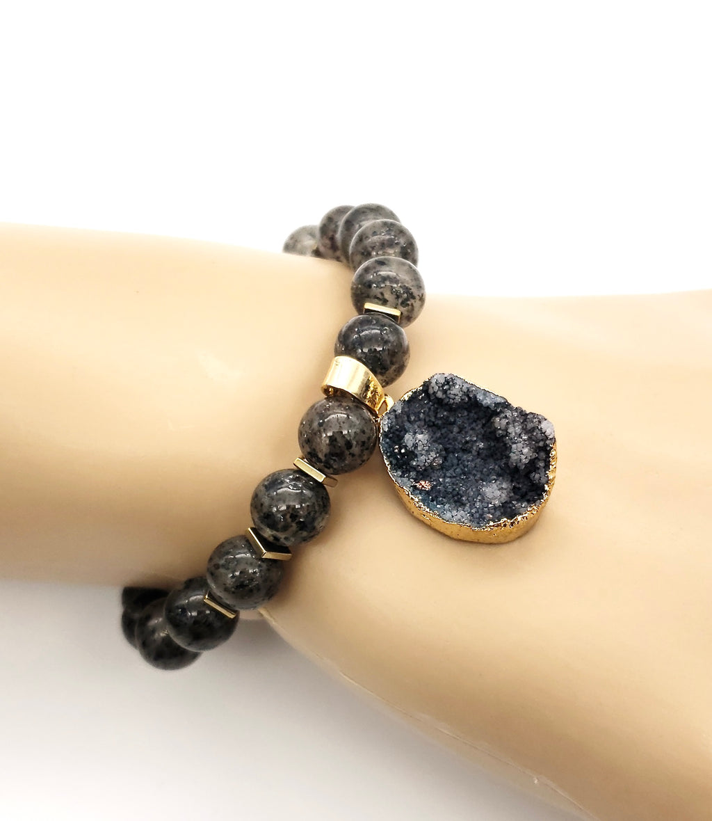 Druzy, iris hematite and rutilated quartz bracelet shown on the wrist