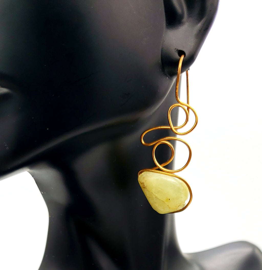 Worn View of Green Garnet Earrings handcrafted in bronze, featuring flowing asymmetrical wirework and natural gemstone beauty.