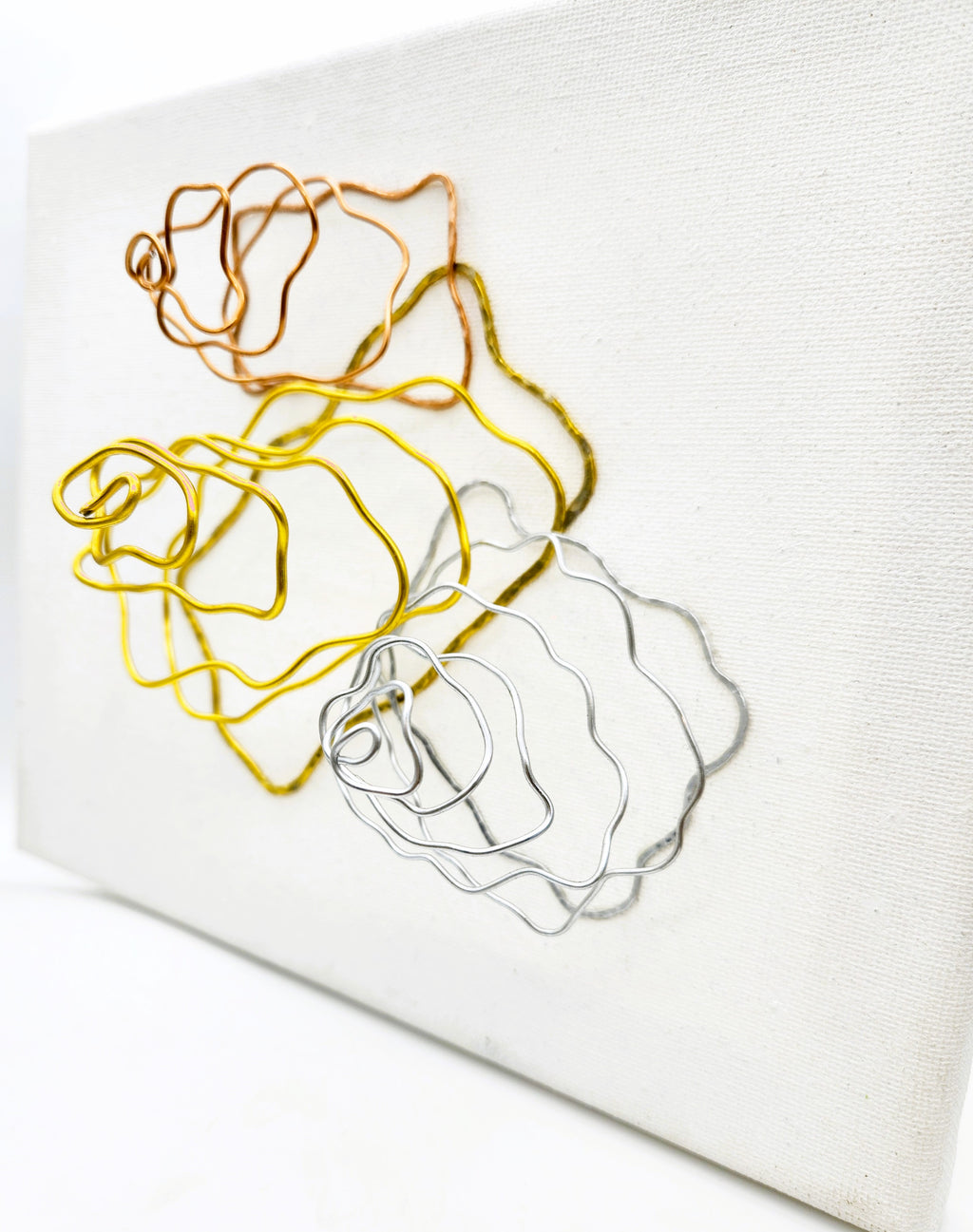 Out Pouring wall art showing its dimensional wire design