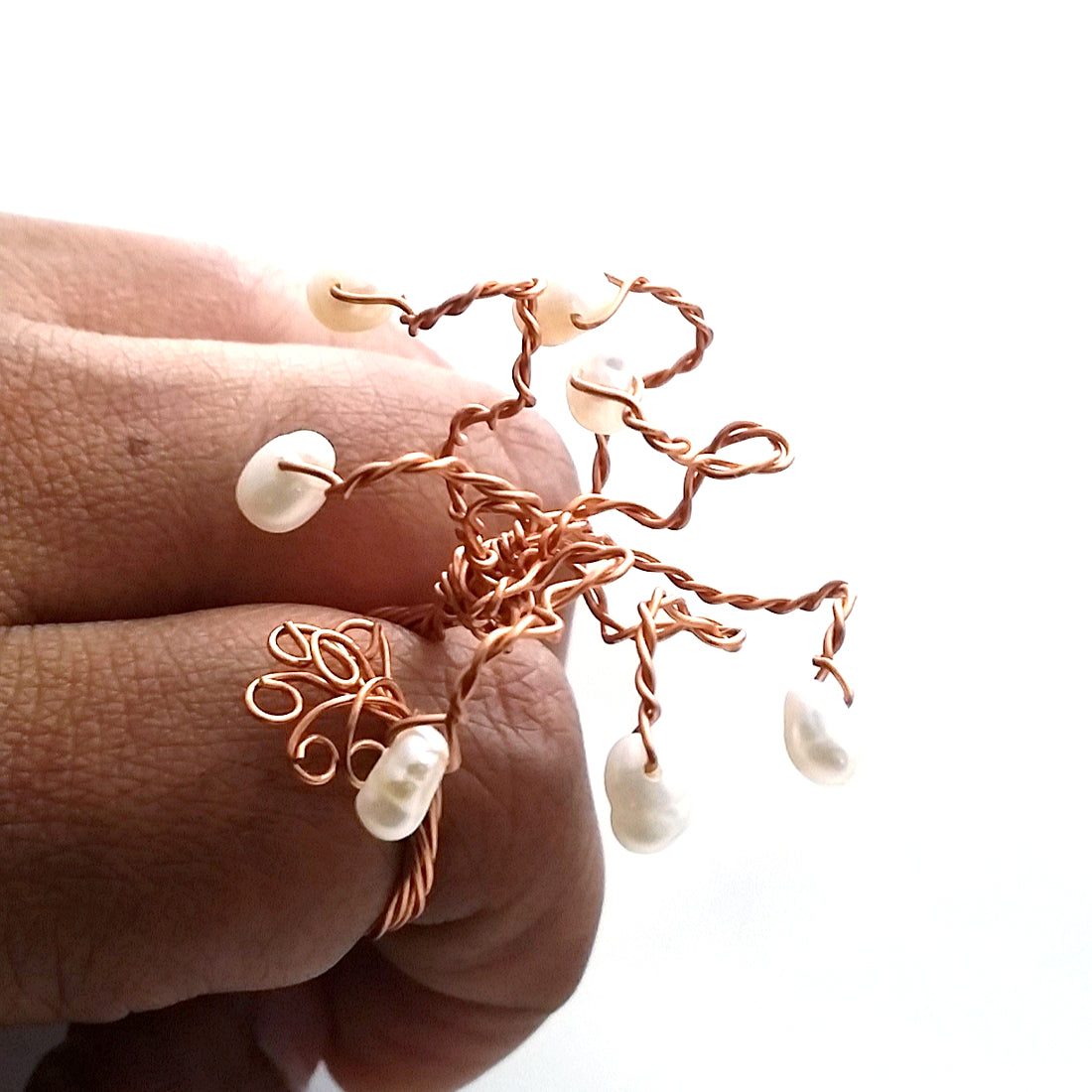 Rooted Tree of Life Ring displayed as wearable sculpture, featuring twisted copper branches and freshwater pearls