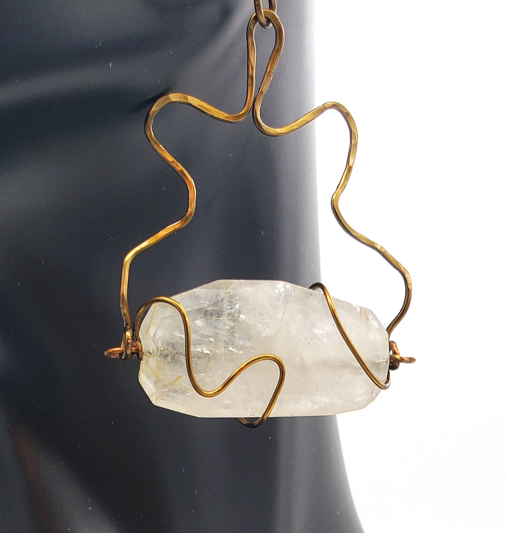 Detailed view of Rutilated Quartz Earrings handcrafted in antiqued brass, featuring natural golden inclusions and sculptural wirework.