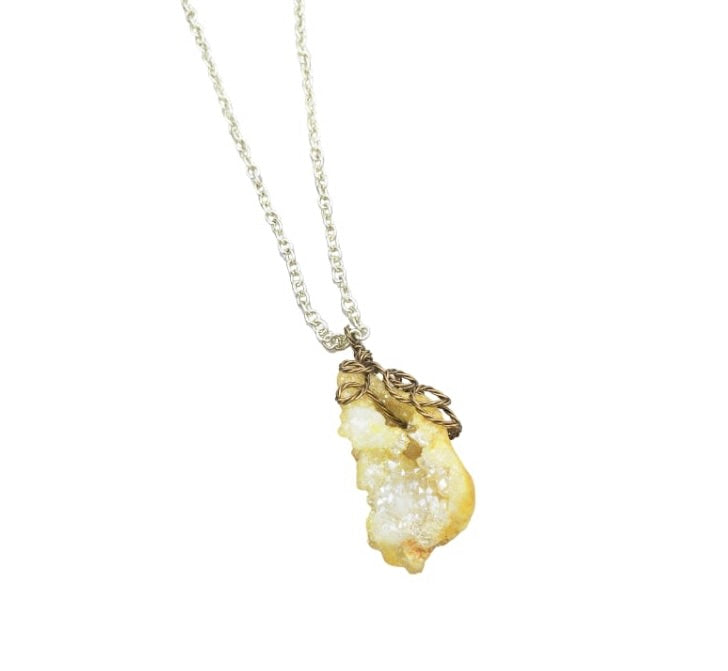 Angled view of Druzy Quartz Necklace handcrafted with antiqued brass.