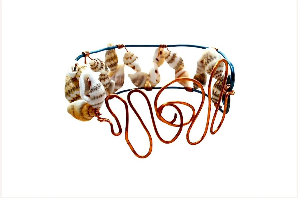 Sculptural copper and shell statement bracelet with blue wire framework and natural shells