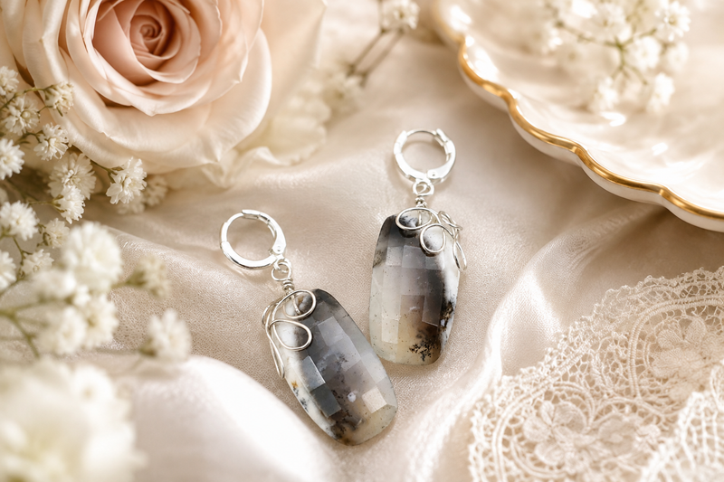 Handcrafted statement earrings styled with ivory florals and soft satin for the Eve Luxurious Elegance jewelry collection.